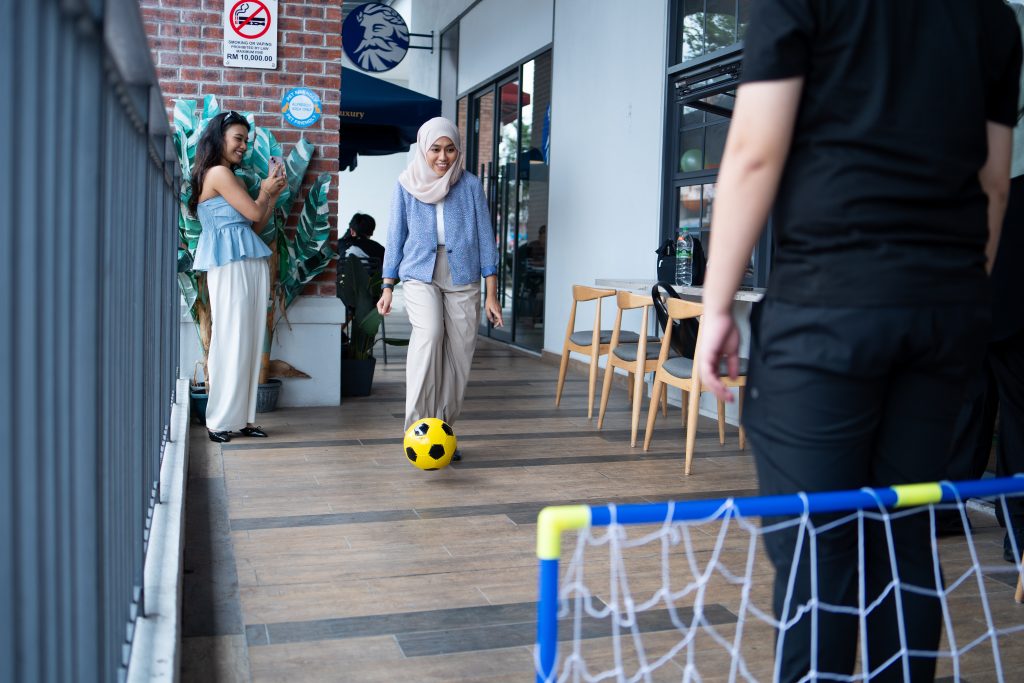 Person playing football at an event.